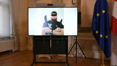 AFP via Getty Images A photo of one of three suspects - seen here holding a knife - arrested in connection with a foiled attack on Taylor Swift's concert in Vienna. Photo: 8 August 2024