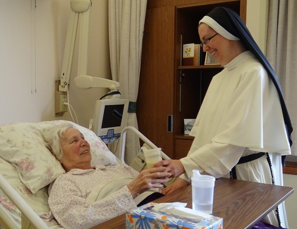 Nun gives care to patient