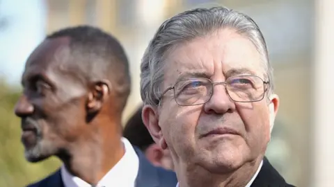 Getty Images Jean-Luc Melenchon of the far -left France Unbowed party is seen with Bally Bagayoko (L) , mayor of Saint-Denis during a protest on September 29, 2026 in Paris, France. Members of France's public sector unions, including teachers, firefighters, healthcare workers and government staff, are striking on Tuesday to pressure the government ahead of its release of the proposed 2027 budget, which reportedly includes cuts and plans to freeze civil servants' base pay for a fourth consecutive year.
