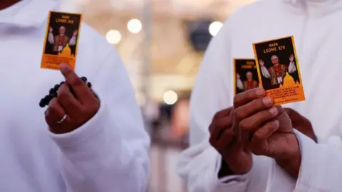 EPA Nuns hold up an image of Pope Leo XIV outside Agostino Gemelli Hospital in Rome, Italy, 13 October 2026.
