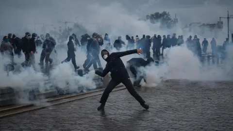 EPA People clash with police during a demonstration against the high cost of living in Bordeaux.